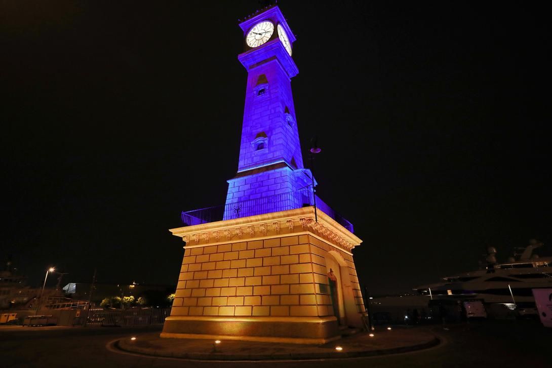 The Clock Tower illuminated with the blue and yellow colours of Ukraine and la Barceloneta.