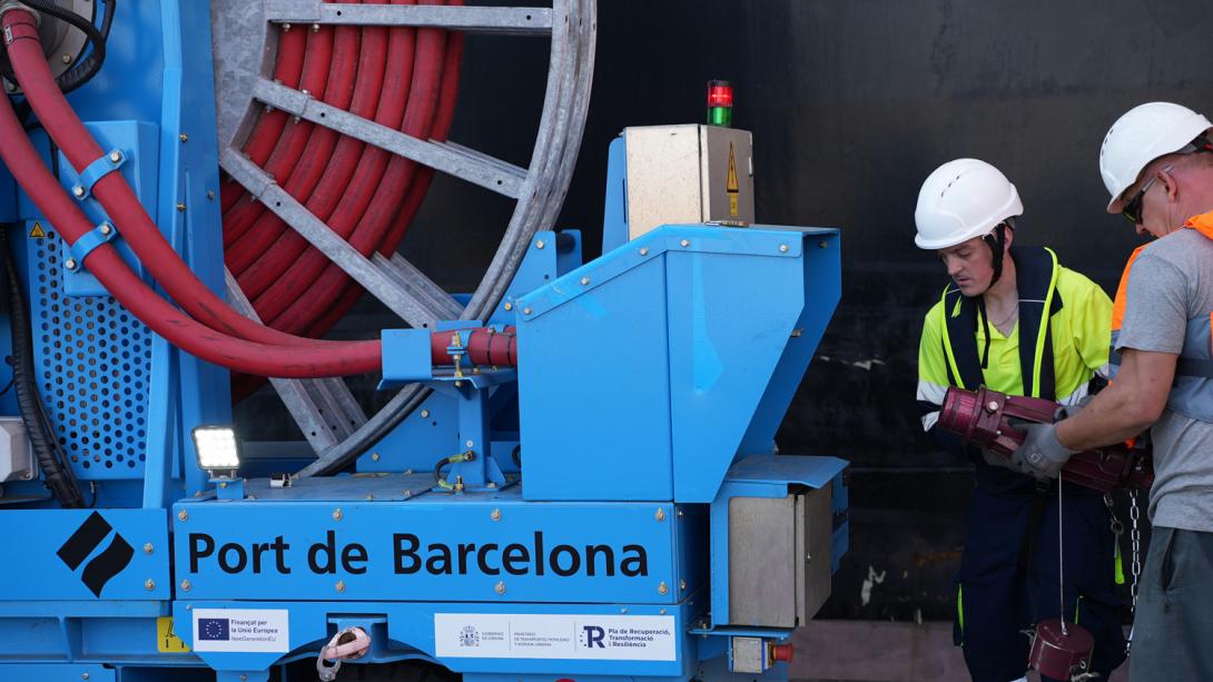 Two operators connect a ship to the OPS on the BEST terminal.